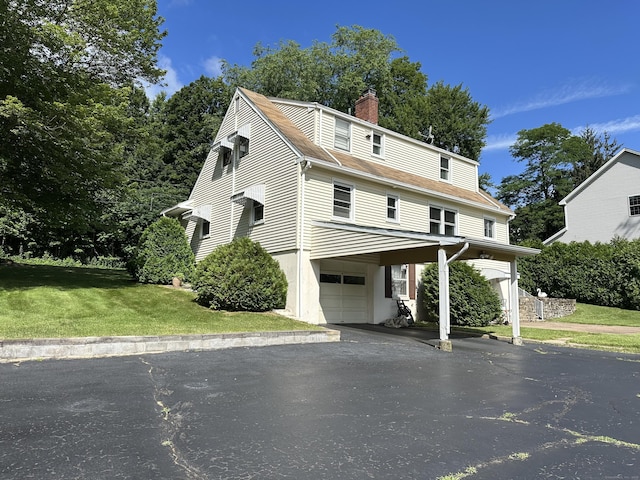 175 Coram Rd, Shelton, CT 06484 - view of front of house with asphalt driveway, a chimney, a garage, and a front yard