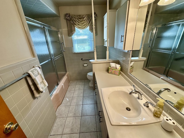 175 Coram Rd, Shelton, CT 06484 - full bath with tile walls, tile patterned floors, vanity, bath / shower combo with glass door, and wainscoting