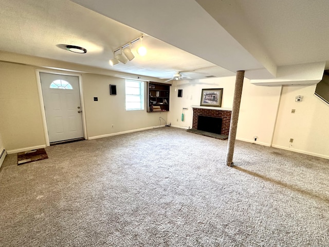 175 Coram Rd, Shelton, CT 06484 - basement featuring ceiling fan, track lighting, a fireplace, and carpet