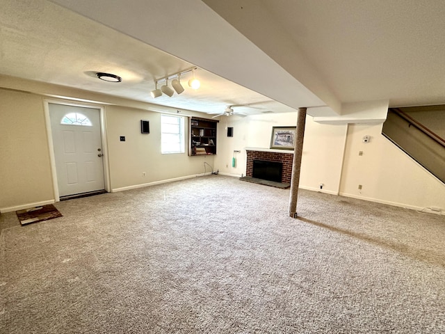 175 Coram Rd, Shelton, CT 06484 - below grade area featuring a fireplace, carpet flooring, ceiling fan, and track lighting