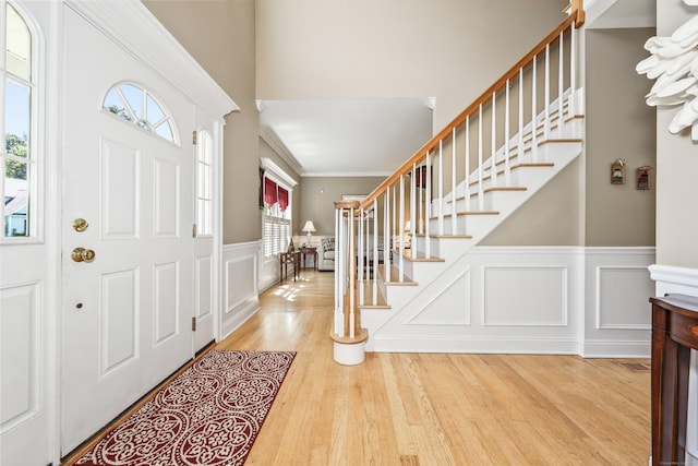 118 Cobblestone Dr, Southington, CT 06479 - foyer entrance with stairs, wood finished floors, wainscoting, a decorative wall, and ornamental molding