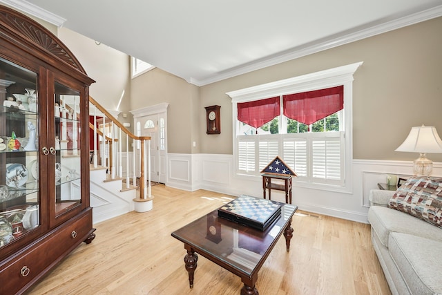 118 Cobblestone Dr, Southington, CT 06479 - living area featuring wainscoting, wood finished floors, stairway, a decorative wall, and crown molding