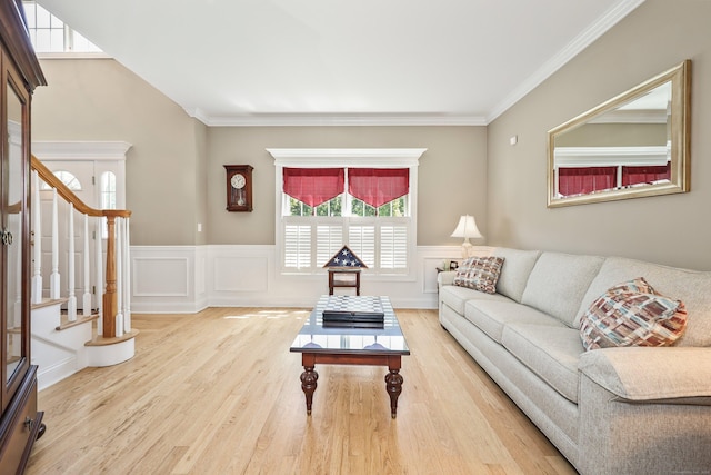 118 Cobblestone Dr, Southington, CT 06479 - living room with healthy amount of natural light, wood finished floors, a wainscoted wall, stairs, and a decorative wall
