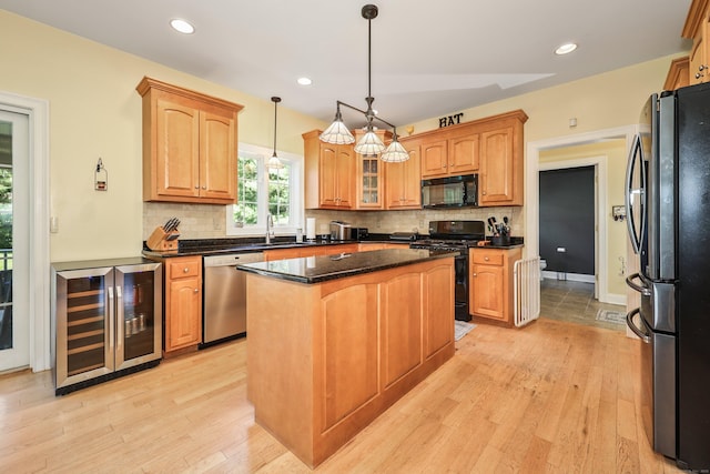 118 Cobblestone Dr, Southington, CT 06479 - kitchen with black appliances, beverage cooler, a kitchen island, tasteful backsplash, and recessed lighting