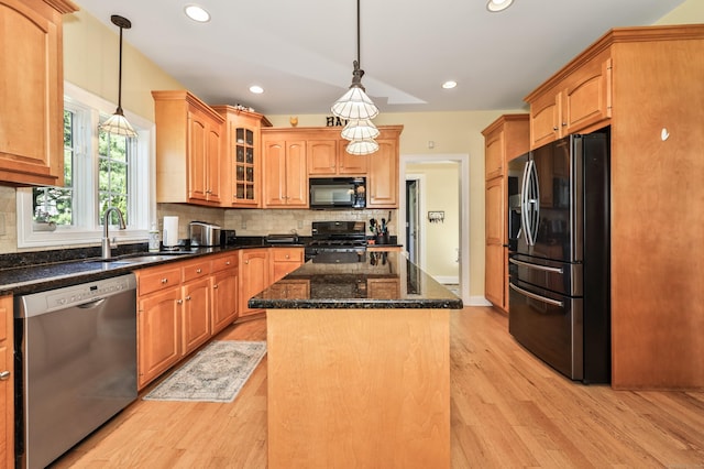 118 Cobblestone Dr, Southington, CT 06479 - kitchen with black appliances, light wood finished floors, a center island, decorative backsplash, and recessed lighting