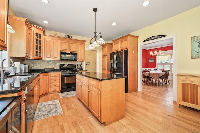 118 Cobblestone Dr, Southington, CT 06479 - kitchen featuring black appliances, a kitchen island, light wood-style floors, a chandelier, and backsplash