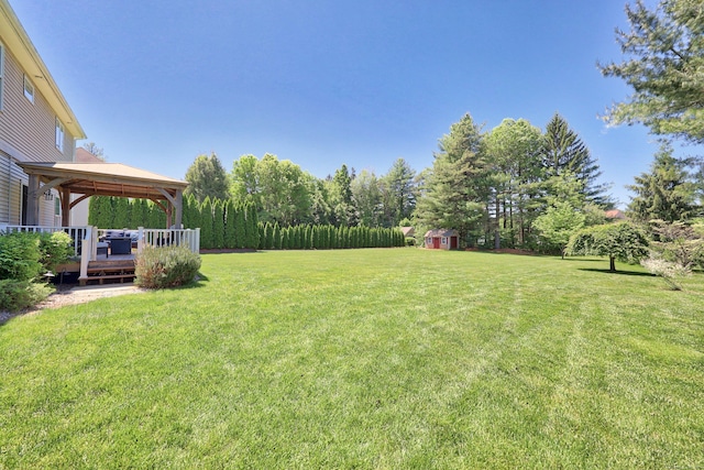 118 Cobblestone Dr, Southington, CT 06479 - view of grassy yard featuring a gazebo, a storage unit, and a wooden deck