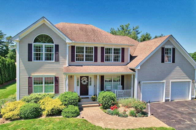 118 Cobblestone Dr, Southington, CT 06479 - traditional-style house featuring a porch, asphalt driveway, roof with shingles, and a garage