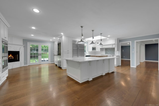 46 Bowman Dr, Greenwich, CT 06831 - kitchen featuring built in appliances, crown molding, recessed lighting, white cabinets, and dark wood-style floors