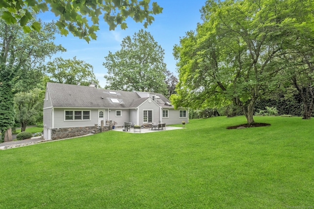 46 Bowman Dr, Greenwich, CT 06831 - back of property with a patio area, entry steps, a yard, and view of scattered trees