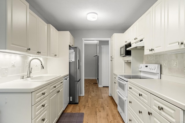 737 Heritage Vlg Unit A, Southbury, CT 06488 - kitchen featuring appliances with stainless steel finishes, tasteful backsplash, under cabinet range hood, and white cabinets