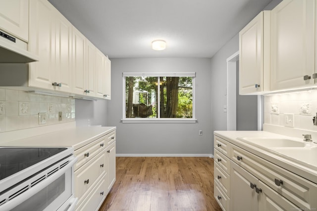 737 Heritage Vlg Unit A, Southbury, CT 06488 - kitchen with electric range, custom range hood, decorative backsplash, and light wood-style flooring