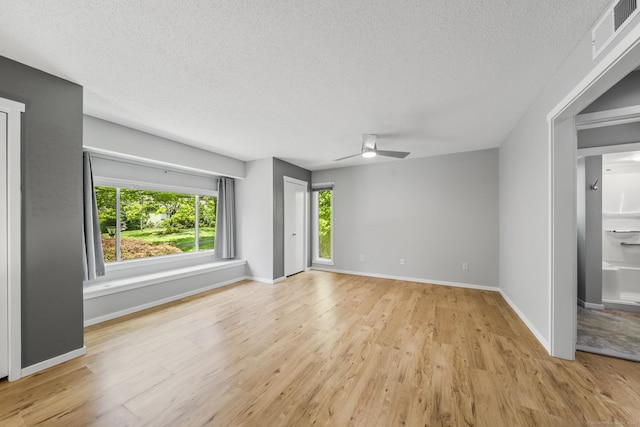737 Heritage Vlg Unit A, Southbury, CT 06488 - unfurnished living room featuring a textured ceiling, ceiling fan, and light wood finished floors
