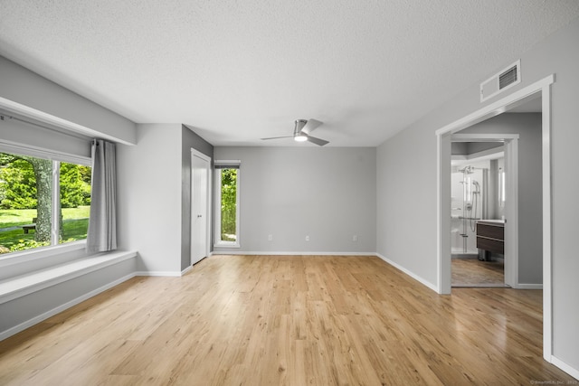 737 Heritage Vlg Unit A, Southbury, CT 06488 - unfurnished room featuring a textured ceiling, a ceiling fan, healthy amount of natural light, and light wood-style flooring