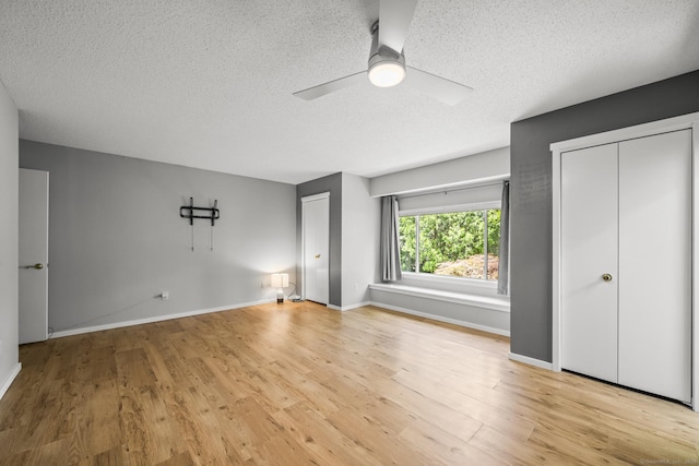 737 Heritage Vlg Unit A, Southbury, CT 06488 - unfurnished bedroom with a textured ceiling, wood finished floors, and a ceiling fan