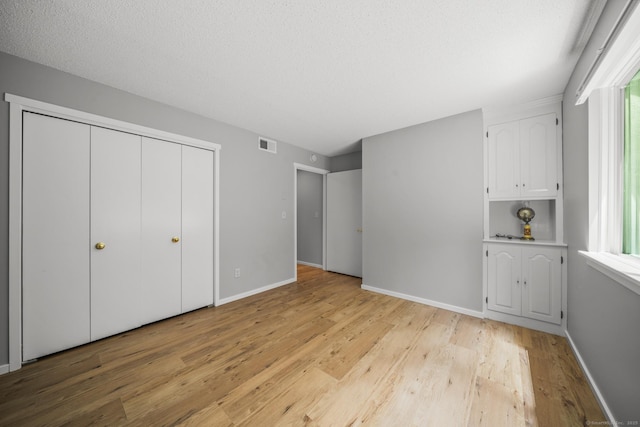 737 Heritage Vlg Unit A, Southbury, CT 06488 - unfurnished bedroom with light wood-style flooring and a closet