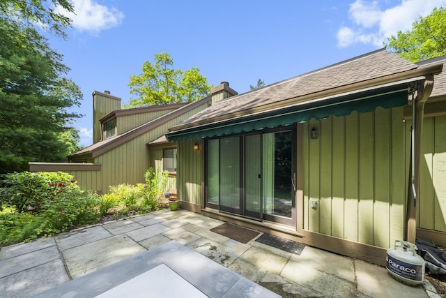 737 Heritage Vlg Unit A, Southbury, CT 06488 - rear view of house with a patio area, a chimney, and roof with shingles