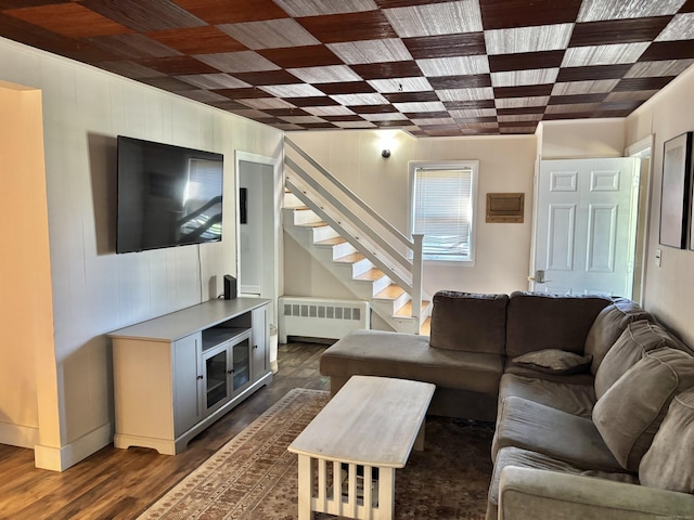 23 Carely Ave, Griswold, CT 06351 - living area featuring radiator, stairs, and dark wood finished floors