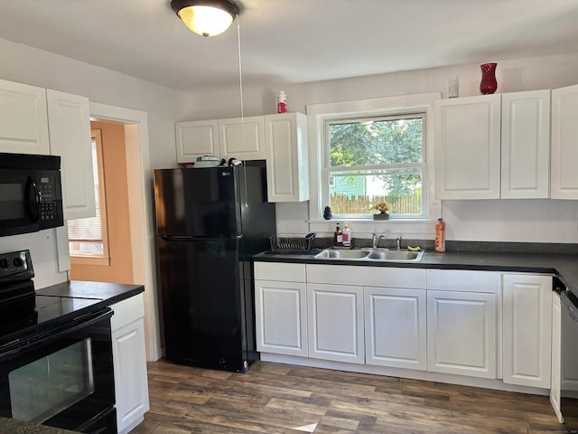 23 Carely Ave, Griswold, CT 06351 - kitchen with black appliances, dark countertops, and white cabinets