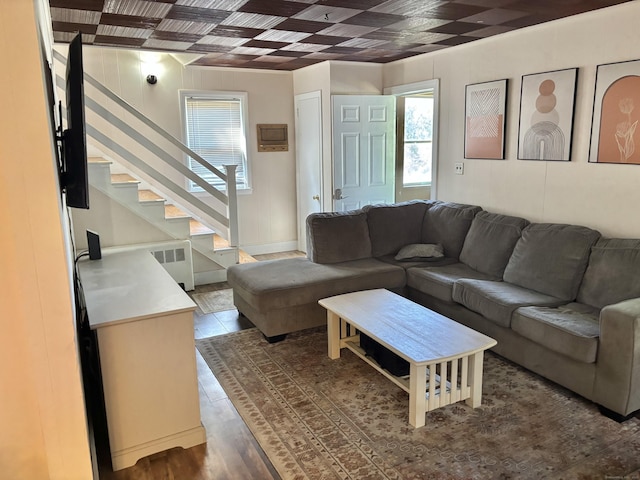23 Carely Ave, Griswold, CT 06351 - living area featuring radiator heating unit, stairs, and wood finished floors