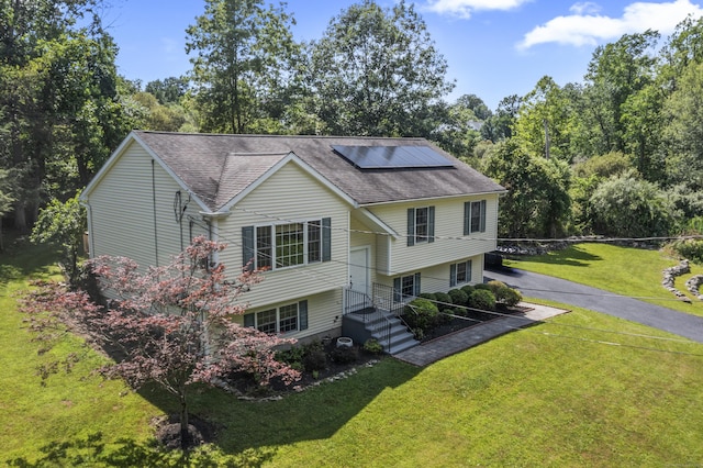 24 Ken Oaks Dr, Danbury, CT 06810 - view of front facade featuring solar panels, a front lawn, and a shingled roof