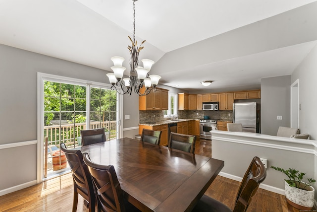 24 Ken Oaks Dr, Danbury, CT 06810 - dining area with a chandelier, light wood-style flooring, and lofted ceiling