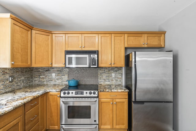 24 Ken Oaks Dr, Danbury, CT 06810 - kitchen featuring stainless steel appliances, tasteful backsplash, light stone counters, and brown cabinets
