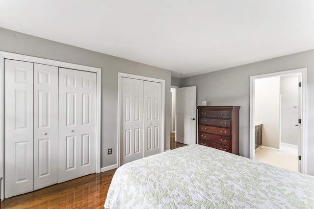 24 Ken Oaks Dr, Danbury, CT 06810 - bedroom featuring two closets, wood finished floors, and ensuite bathroom