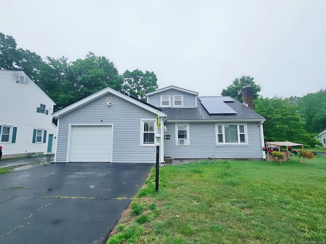 209 Maple St, East Hartford, CT 06118 - traditional-style house with a chimney, solar panels, asphalt driveway, a front yard, and roof with shingles