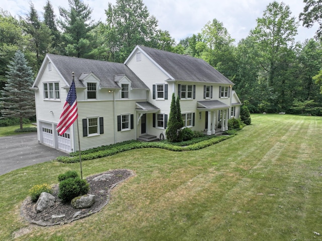 35 Vista Rd, Wilton, CT 06897 - view of front of property featuring asphalt driveway, an attached garage, a front lawn, and a shingled roof