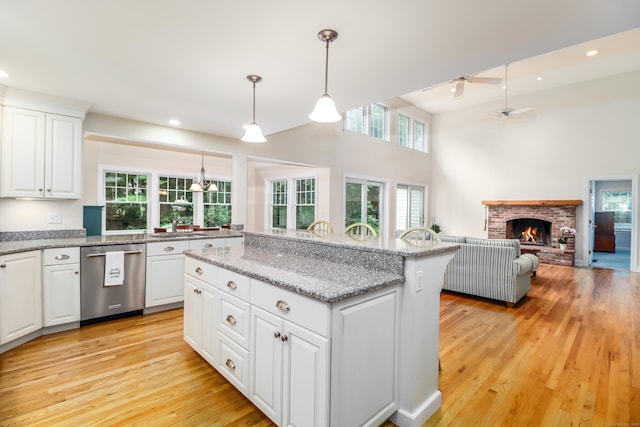 35 Vista Rd, Wilton, CT 06897 - kitchen with dishwasher, a ceiling fan, light wood-style flooring, a fireplace, and a kitchen island