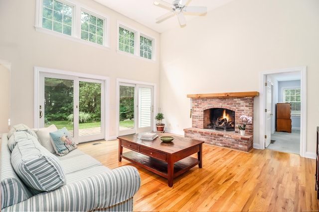 35 Vista Rd, Wilton, CT 06897 - living area with a high ceiling, light wood-style flooring, a ceiling fan, and a fireplace