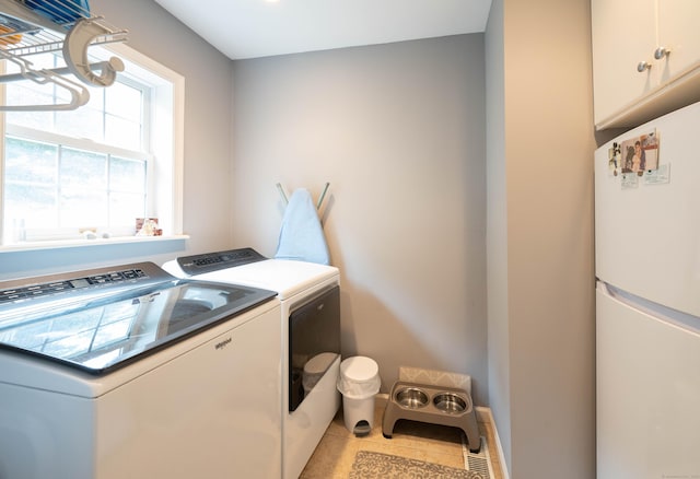30 Partridge Rd, Stamford, CT 06903 - laundry room featuring cabinet space, washer and clothes dryer, and light tile patterned floors