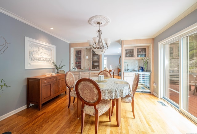 30 Partridge Rd, Stamford, CT 06903 - dining area with a chandelier, wine cooler, healthy amount of natural light, light wood-style flooring, and crown molding