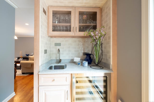 30 Partridge Rd, Stamford, CT 06903 - indoor wet bar with beverage cooler, tasteful backsplash, light wood finished floors, and ornamental molding