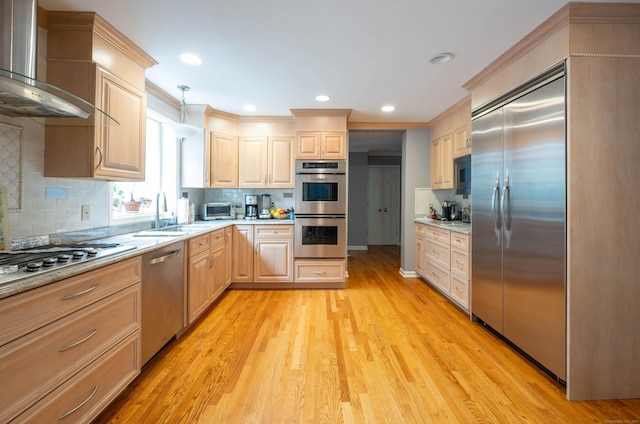 30 Partridge Rd, Stamford, CT 06903 - kitchen with stainless steel appliances, wall chimney range hood, light brown cabinets, ornamental molding, and light wood-style floors