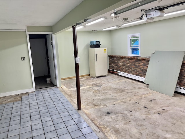 3 Millstream Rd, Hebron, CT 06231 - basement with freestanding refrigerator, a baseboard heating unit, and brick wall