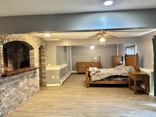 3 Millstream Rd, Hebron, CT 06231 - bedroom featuring wood finished floors, a baseboard heating unit, and brick wall