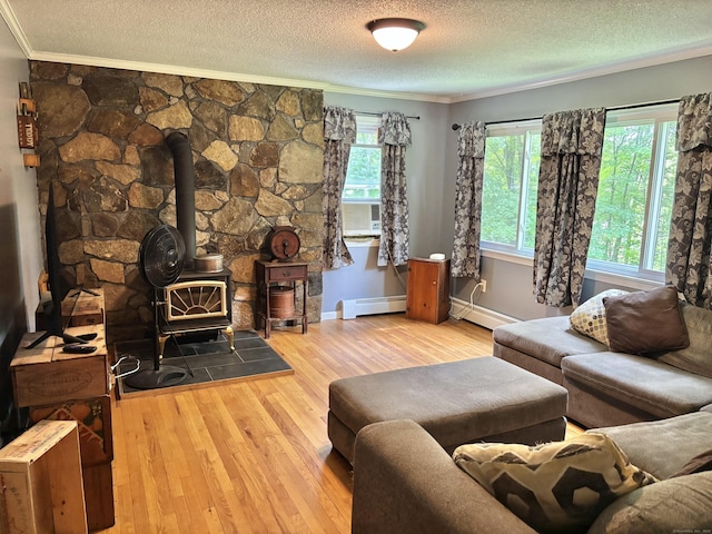 3 Millstream Rd, Hebron, CT 06231 - living area with ornamental molding, baseboard heating, a wood stove, a textured ceiling, and hardwood / wood-style floors