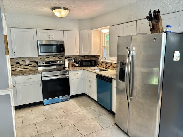 3 Millstream Rd, Hebron, CT 06231 - kitchen with appliances with stainless steel finishes, tasteful backsplash, white cabinets, light stone countertops, and a textured ceiling