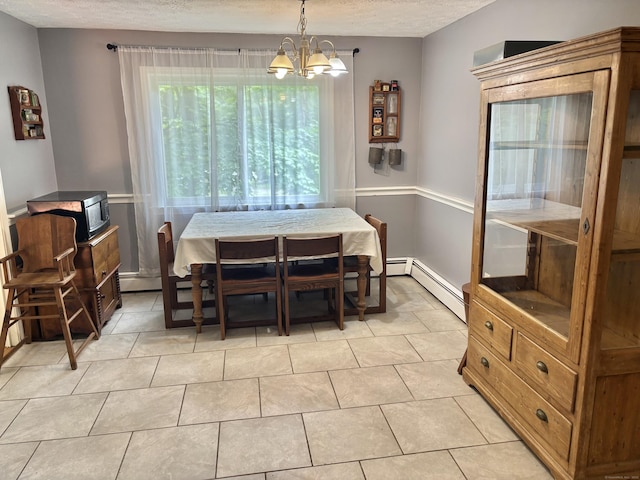 3 Millstream Rd, Hebron, CT 06231 - dining space with a chandelier, a baseboard heating unit, a textured ceiling, and light tile patterned flooring