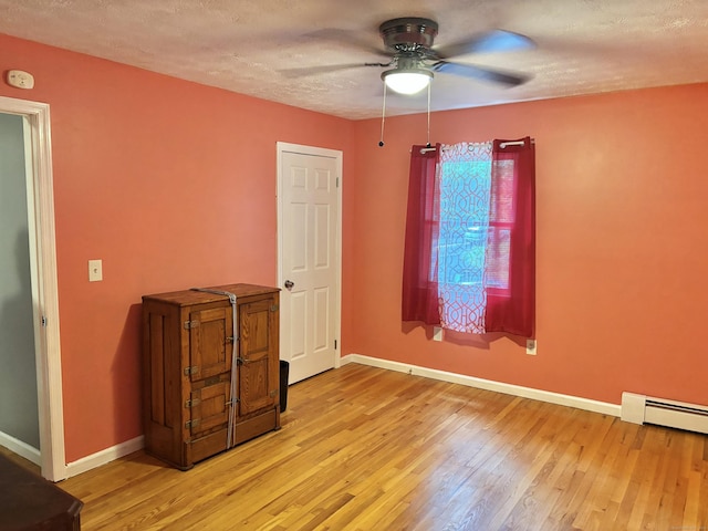 3 Millstream Rd, Hebron, CT 06231 - spare room featuring a ceiling fan, light wood-style flooring, a smoke detector, baseboard heating, and a textured ceiling