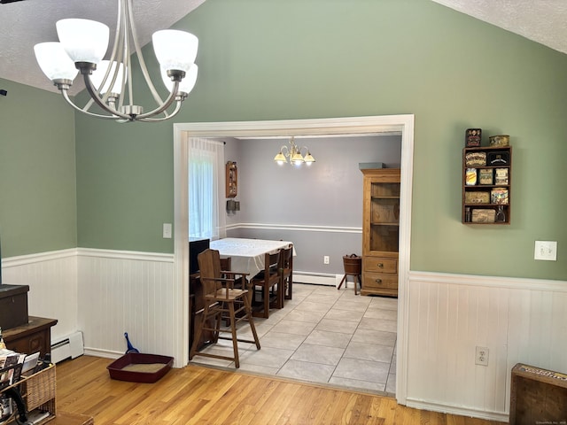 3 Millstream Rd, Hebron, CT 06231 - dining area with a chandelier, a baseboard radiator, wainscoting, light wood finished floors, and vaulted ceiling