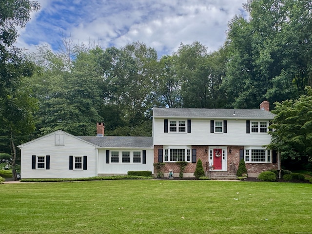 475 Riverside Dr, Cheshire, CT 06410 - view of front facade featuring brick siding, a chimney, and a front yard