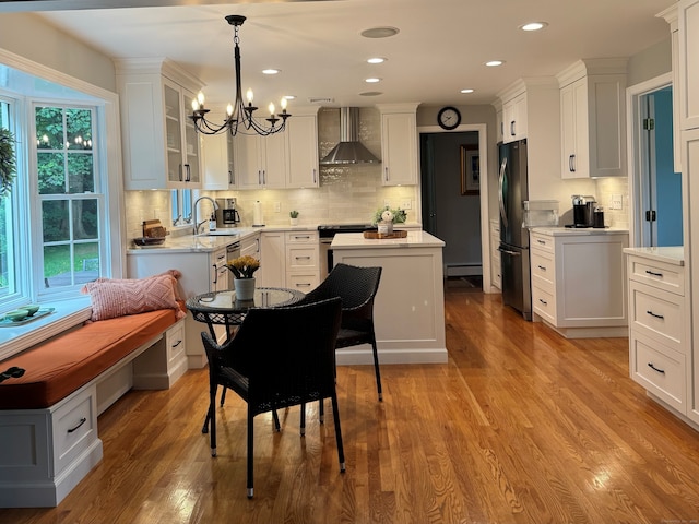 475 Riverside Dr, Cheshire, CT 06410 - kitchen featuring wall chimney exhaust hood, appliances with stainless steel finishes, a chandelier, white cabinets, and recessed lighting