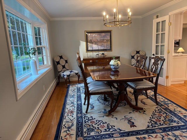 475 Riverside Dr, Cheshire, CT 06410 - dining area with a baseboard radiator, a chandelier, light wood-style flooring, and crown molding