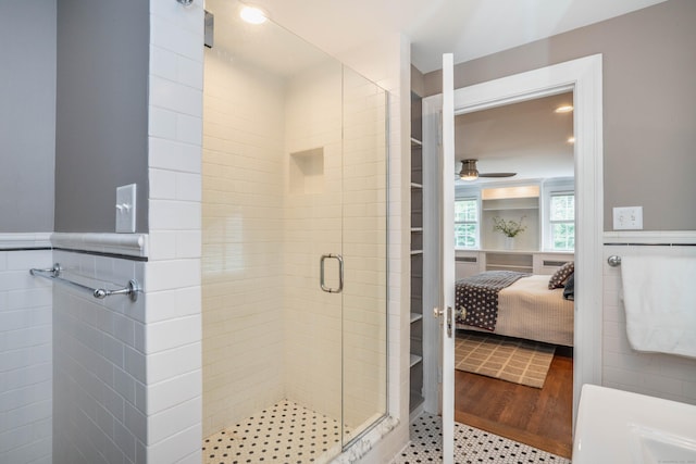 35 Walker Ln, West Hartford, CT 06117 - ensuite bathroom with a stall shower, a wainscoted wall, a ceiling fan, and a walk in closet