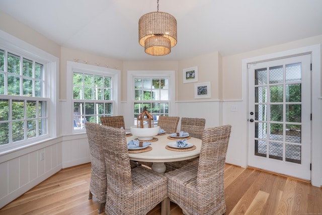 35 Walker Ln, West Hartford, CT 06117 - dining space featuring light wood-style flooring, a decorative wall, a chandelier, and wainscoting