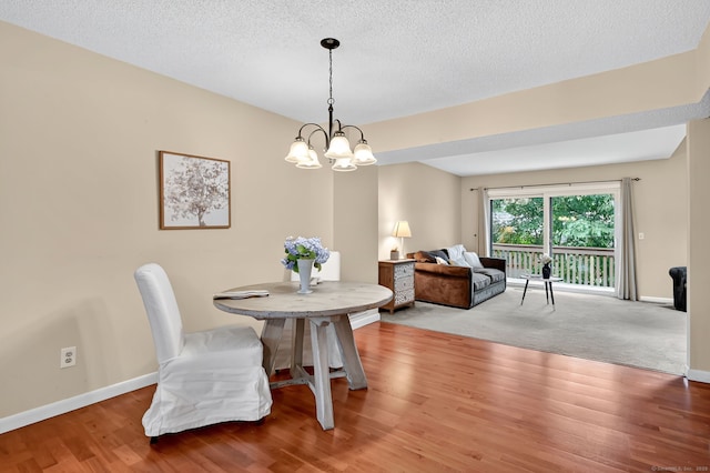 55 Wickhams Fancy Unit 55, Canton, CT 06019 - dining room featuring a chandelier, wood finished floors, and a textured ceiling