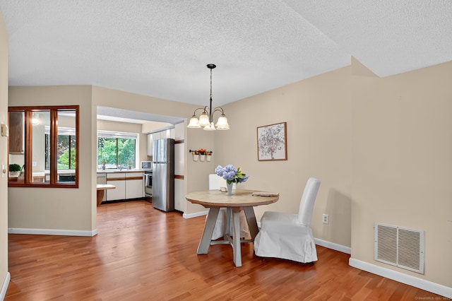 55 Wickhams Fancy Unit 55, Canton, CT 06019 - dining space with a textured ceiling, light wood finished floors, and a chandelier